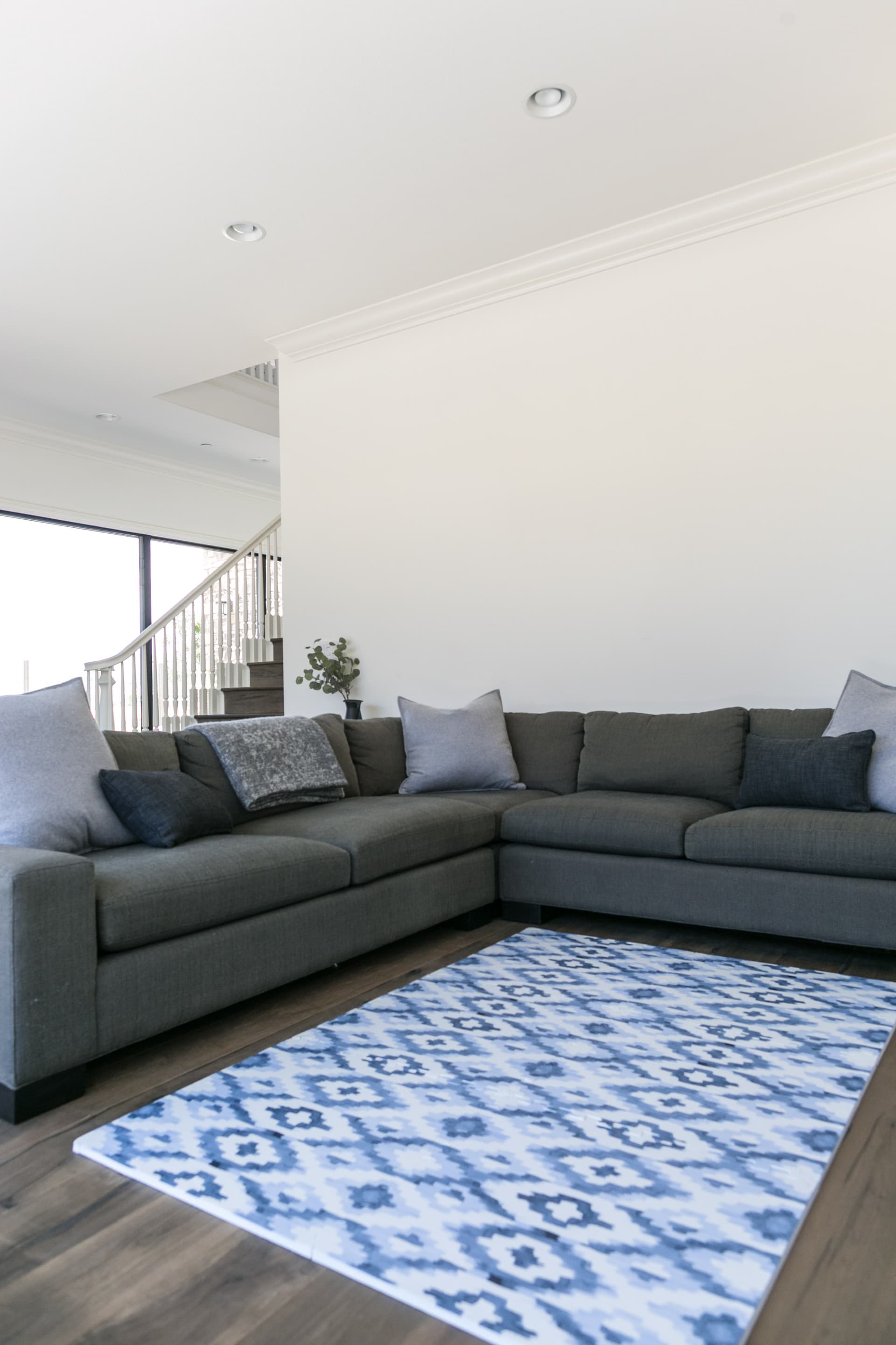 Baby playing on Everline foam play mat in a bright modern nursery